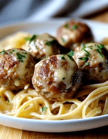 Easy Garlic Butter Meatballs served over creamy Parmesan linguine