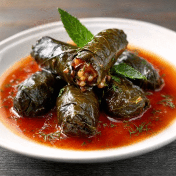 Stuffed Grape Leaves with Cinnamon Tomato Sauce